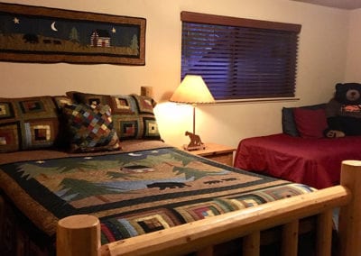 Photo of a bedroom with one queen and one single bed