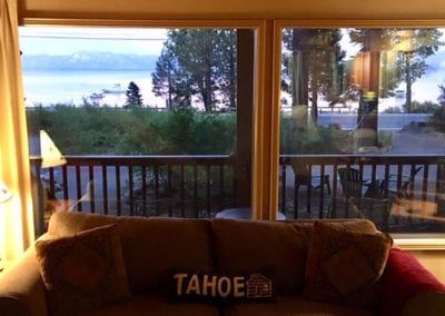 Photo of a couch and view of the lake through the window